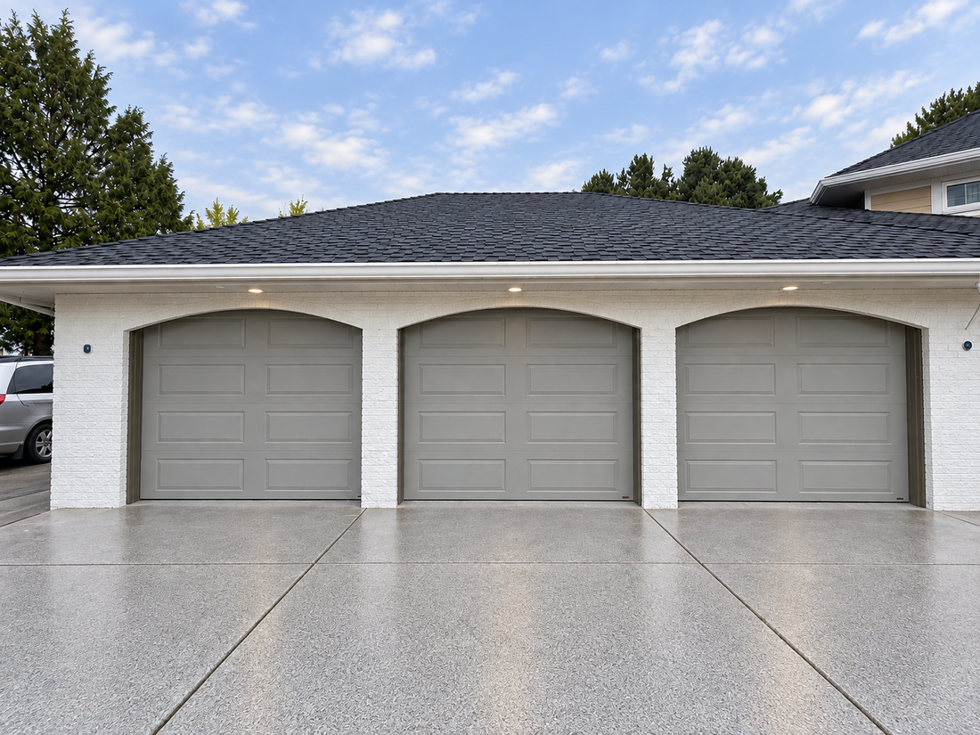 Three custom-colour Hörmann Clima Tech 4400 garage doors beneath arched openings in Richmond, BC