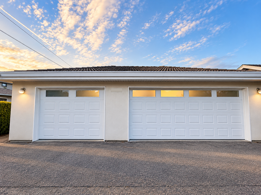 Completed white Hörmann Clima Tech 4400 garage door upgrade with glazed top sections and matching single and double bays