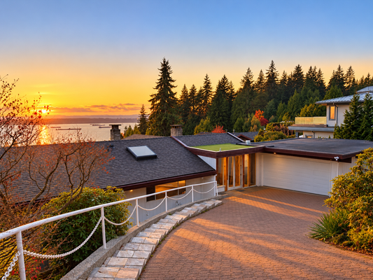 Completed West Vancouver residence at sunset with a white Pro Tech 2500 garage door beside the entrance
